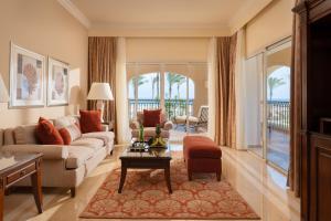 a living room with a couch and a table at Jaz Almaza Beach Resort, Almaza Bay in Marsa Matruh