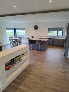 a kitchen and dining room with a table and chairs at Stable Hill House in Killarney