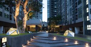 a walkway in a city at night with lights at The Base Central Pattaya by Adam in Pattaya
