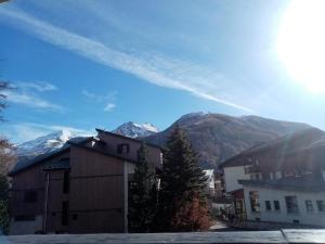 a building with a mountain in the background at Logement tout confort Val d'Isere in Le Joseray +7 photos