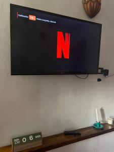 a flat screen tv hanging on a wall at La Casita de La Esperanza in La Esperanza
