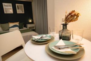 a table with two plates and a vase on it at shinjuku1 in Tokyo