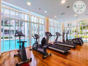 a gym with treadmills and elliptical machines at Medini Signature by JBcity Home in Nusajaya