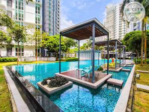 a large swimming pool in a city with tall buildings at Medini Signature by JBcity Home in Nusajaya