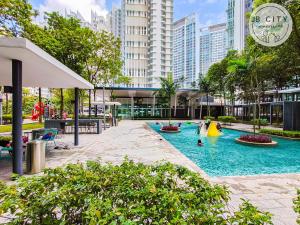 a pool in a city with buildings in the background at Medini Signature by JBcity Home in Nusajaya