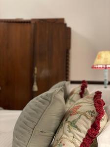 a couch with a pillow on it with a lamp at Casa Colonial El Indiano in Las Palmas de Gran Canaria