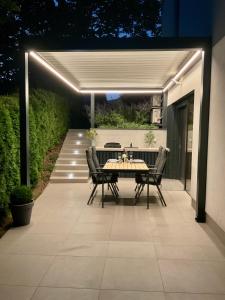 a patio with a table and chairs under a pergola at Studio ELITE in Bled