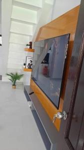 a living room with a large flat screen tv at 2 Bedroom Townhouse- Near Clark Airport in Angeles