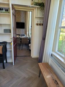 a door leading into a dining room with a table at Pastorie Waaxens in Waaxens