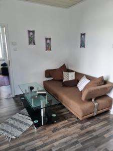 a living room with a couch and a glass table at Drea's Ferienwohnung in Wermelskirchen