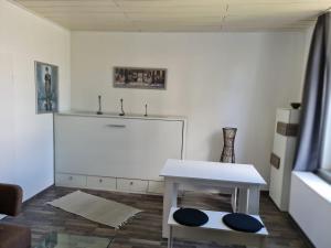 a living room with a white table and a couch at Drea's Ferienwohnung in Wermelskirchen