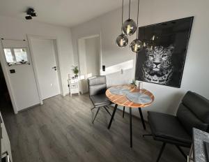 a dining room with a table and chairs in a room at Nollywood-Apartment in Rheinfelden +9 photos