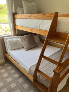 a couple of bunk beds in a room at Bella Casa - Seaview-Beach Club Apartment in Cape Town