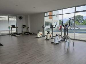 a gym with several treadmills and elliptical machines at HK Homestay in Ipoh