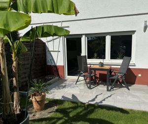 a patio with a table and two chairs and a table at Nollywood-Apartment in Rheinfelden