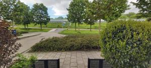 a walkway in a park with bushes and trees at spacious room with free parking in Almere