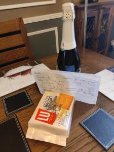 a bottle of wine and a book on a table at Brads Place - Central Ballymena close to everything in Ballymena