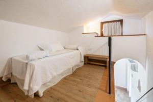 En eller flere senge i et værelse på Tenuta Querce Grosse- Le Dimore