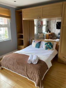 a bedroom with a large bed with towels on it at Stunning 1-Bed Apartment in London in London