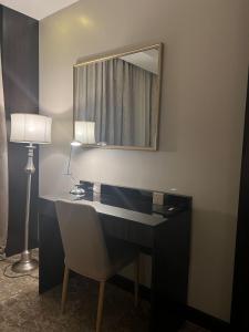 a bathroom with a desk with a mirror and a lamp at Crystal Blue Rabigh 2 in Rabigh