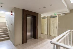 a hallway with doors and stairs in a building at AMANI 729, 3 Minutes to Airport, 100mbps Wi-Fi, Free Netflix in Pusok