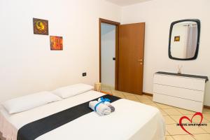 a bedroom with a bed with a stuffed animal on it at In Love in Montichiari