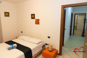 a bedroom with two beds and a mirror at In Love in Montichiari