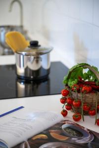 a basket of strawberries sitting on a counter next to a book at Casa Luma, il sogno di Positano! in Positano