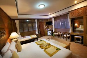 a bedroom with a bed and a room with a tub at Smile House - Fisherman Village in Bophut
