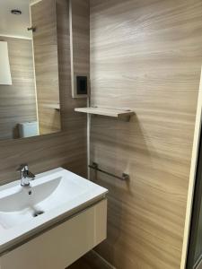 a bathroom with a white sink and a mirror at Villaggio Turistico Maderno in Toscolano Maderno