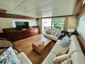 a living room with a couch and a tv on a boat at MotorYacht 21 avec équipage in Barcelona