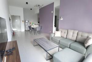 a living room with a couch and a table at G Residence - 2R2B Barrington Night Market (2) in Brinchang