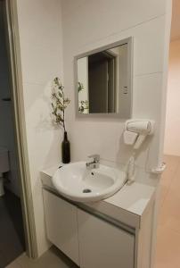 a white bathroom with a sink and a mirror at G Residence - 2R2B Barrington Night Market (2) in Brinchang +14 photos