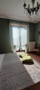 a bedroom with a large bed with a large window at Casa Vacanze Le tre Sorelle in Torre Pellice