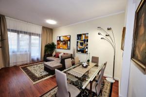 a living room with a table and a couch at Vatican luxury - private parking free - meospiti luxury in Rome
