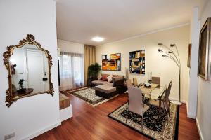 a living room with a table and a mirror at Vatican luxury - private parking free - meospiti luxury in Rome