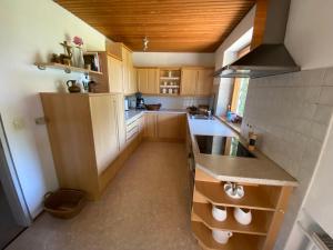 a kitchen with wooden cabinets and a counter top at Haus Gert in Mellrichstadt
