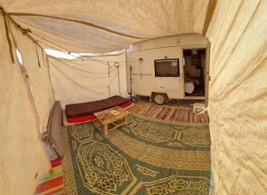an interior view of a tent with a tv in it at ג'וני- חוויה בקארוון מדברי in Sappir