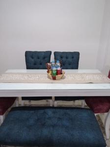 a table with two chairs and a bowl of bottles on it at 2 bedrooms private townhouse in Zayed in Sheikh Zayed