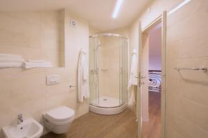 a bathroom with a shower and a toilet and a sink at Aparthotel Villa Aria in Budva +41 photos