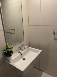 a white bathroom with a sink and a mirror at 104at77 Independence Street - Windhoek in Windhoek