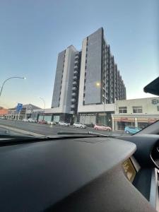 a view from a car windshield of a large building at 104at77 Independence Street - Windhoek in Windhoek