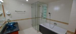 a bathroom with a shower and a tub and a toilet at City Garden Pattaya - 2br Suite, 76sqm in Pattaya Central