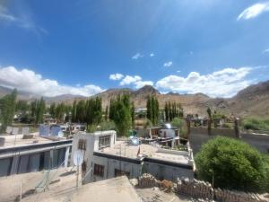 arial view of a building with mountains in the background at Smanla guest house in Leh