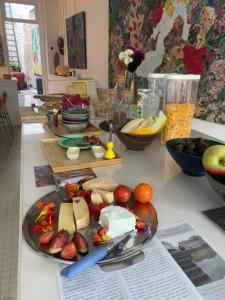 une table avec une plaque de fromage et d'autres denrées alimentaires dans l'établissement galerie jacqueline storme, à Lille