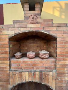 a brick oven with three pots on top of it at Helios Arabians in Cairo