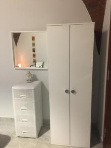 a white closet with a mirror and a dresser at Helios Arabians in Cairo