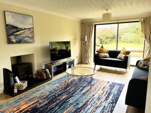 a living room with a couch and a coffee table at Partridge House • Sleeps 9 in Oakham