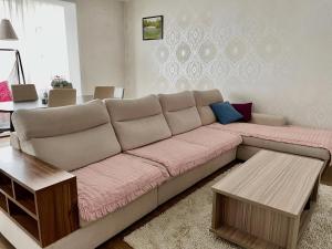 a living room with a couch and a table at Spacious 140m2, 2 bedrooms apartment in Ulaanbaatar