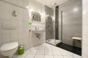a bathroom with a toilet and a sink and a shower at Maria Gabriele Karlstrasse 6b Ferienwohnung 12 in Kolpinsee +12 photos